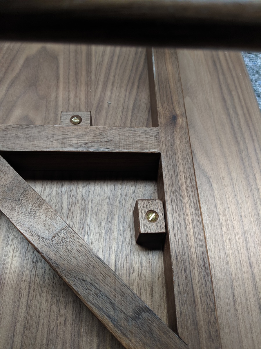 Table top buttons fastened with brass screws